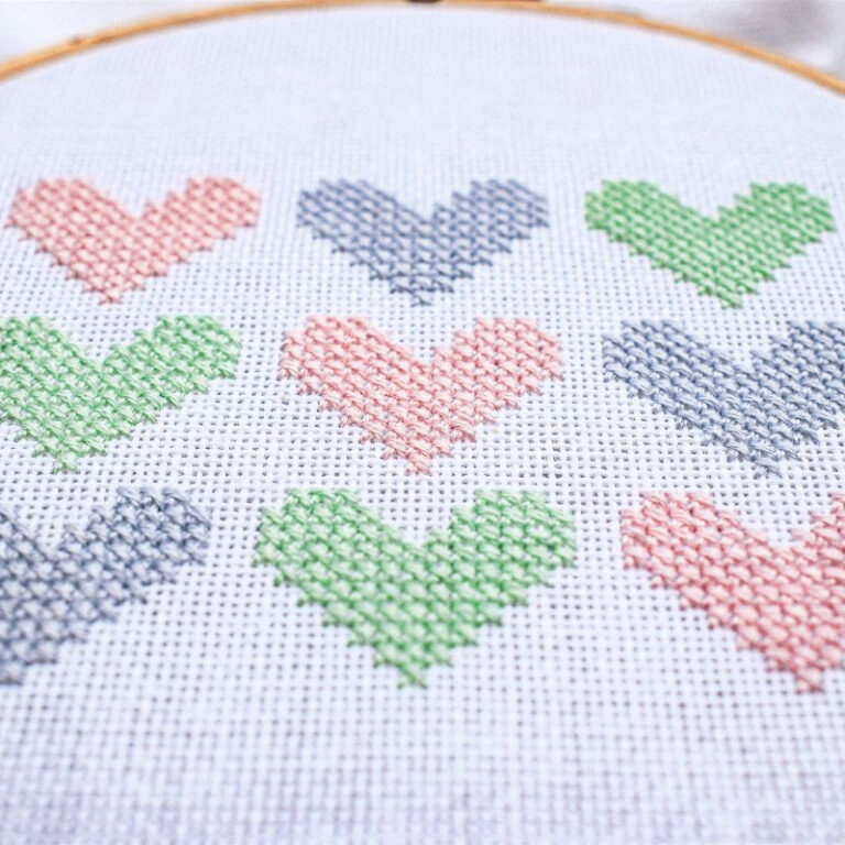 embroidered and framed in a hoop hearts cross stitch sampler