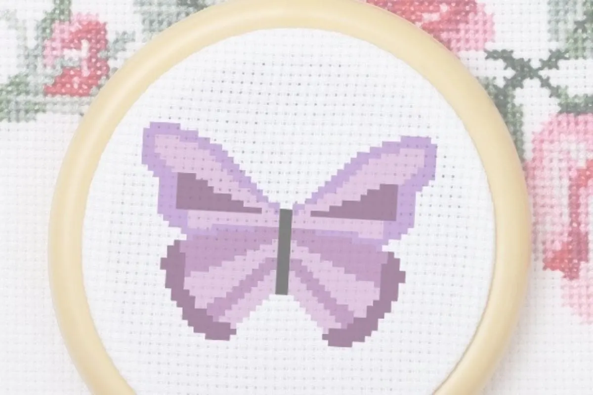 embroidered and framed in a hoop purple simple butterfly cross stitch