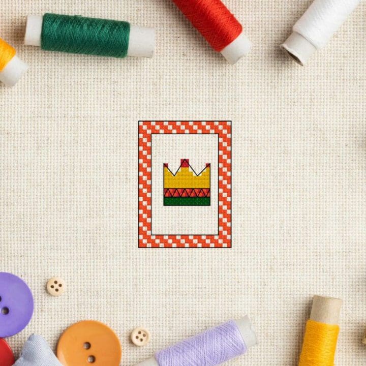 embroidered Free crown cross stitch pattern on aida fabric with threads surrounding