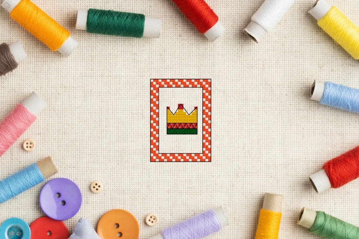 embroidered Free crown cross stitch pattern on aida fabric with threads surrounding