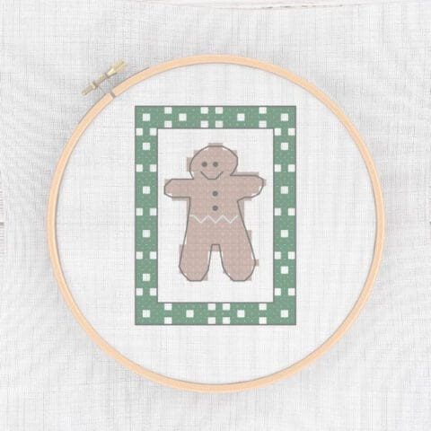 embroidered and framed mini gingerbread man cross stitch