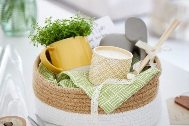 Fabric basket on white table cloth with easter decorations inside