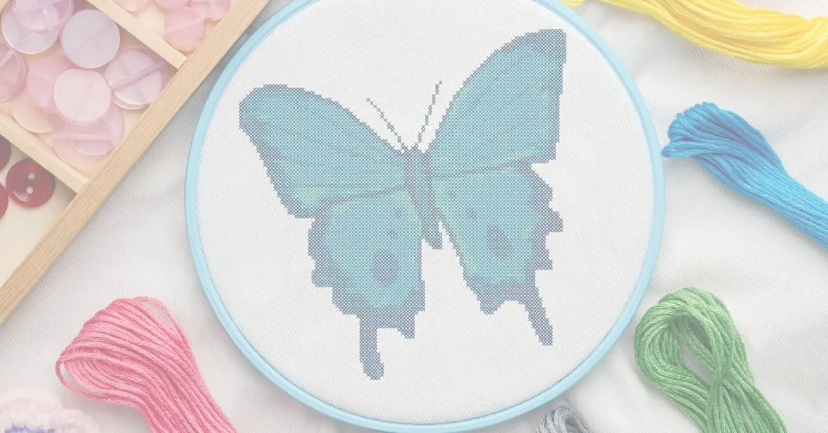 embroidered and framed in a hoop tropical blue butterfly cross stitch