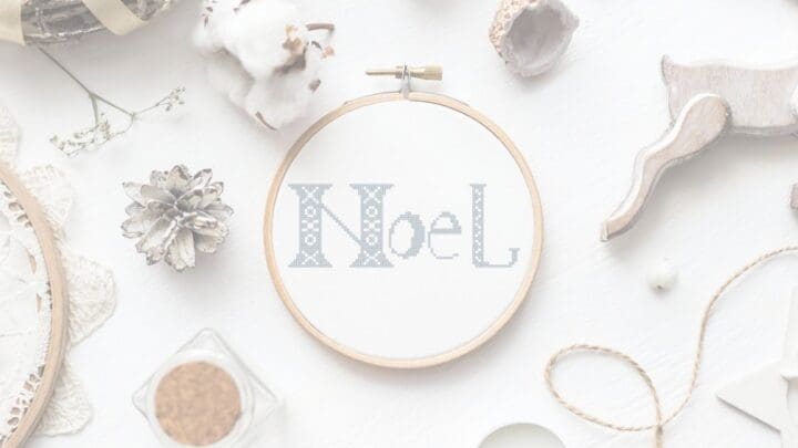 embroidered and framed in hoop Noel cross stitch