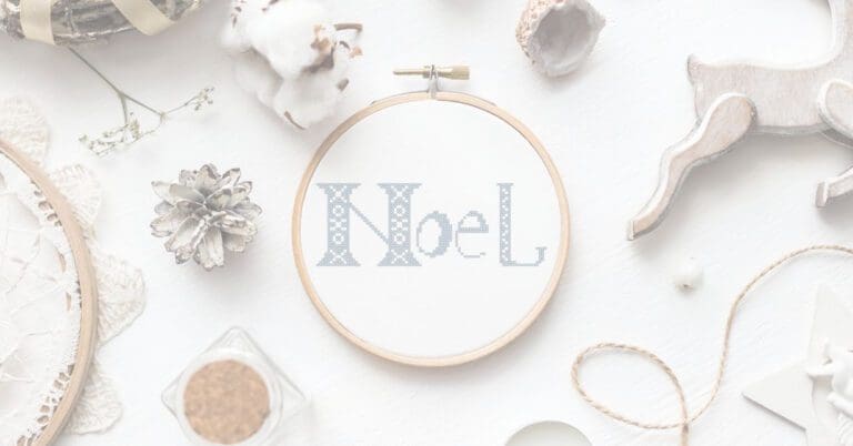 embroidered and framed in hoop Noel cross stitch