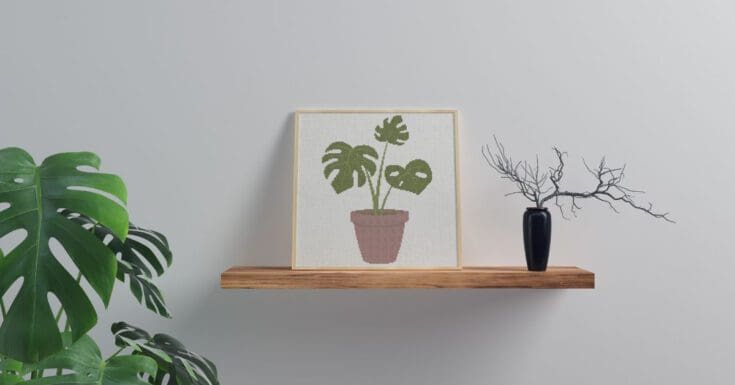 embroidered and framed Monstera cross stitch