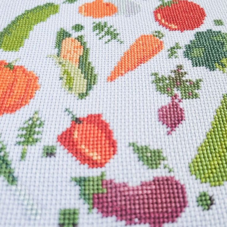 embroidered and framed in a hoop fresh vegetables cross stitch