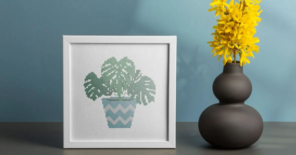 embroidered and framed cheese plant cross stitch