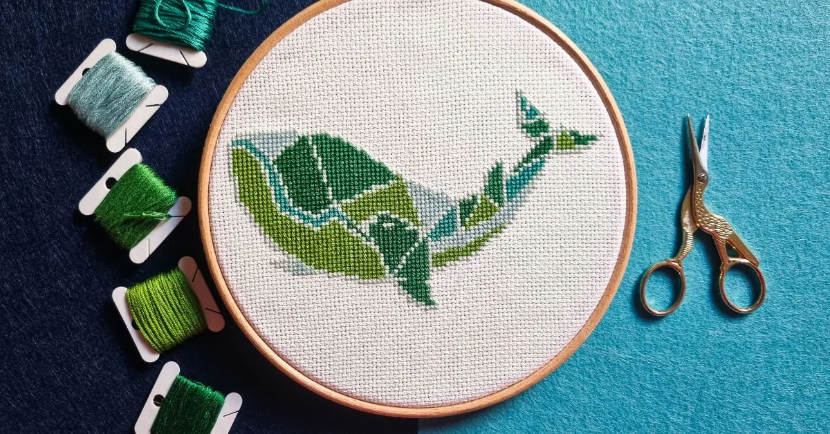 embroidered and framed in a hoop geometric whale cross stitch