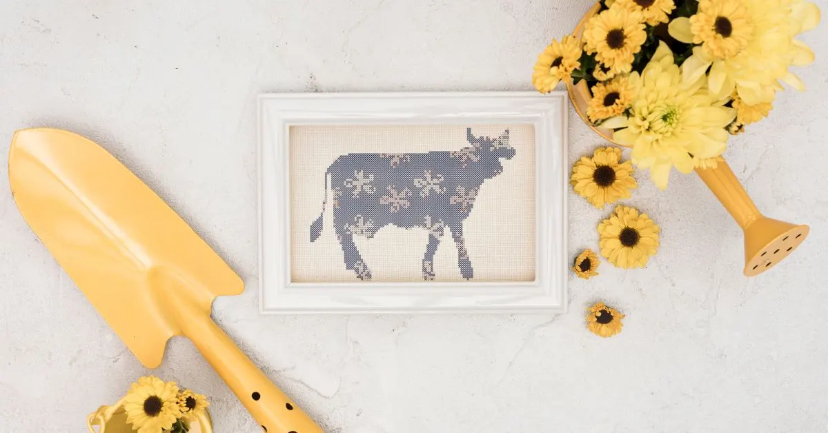 embroidered and framed floral cow cross stitch