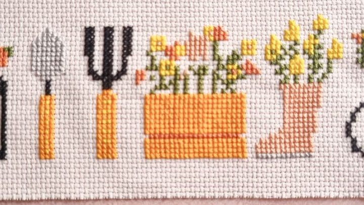 close up of embroidered cross stitch garden motifs
