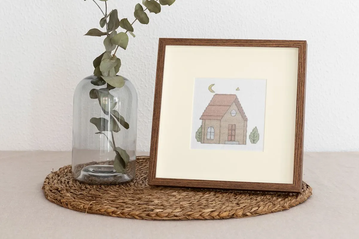 embroidered and framed cabin cross stitch