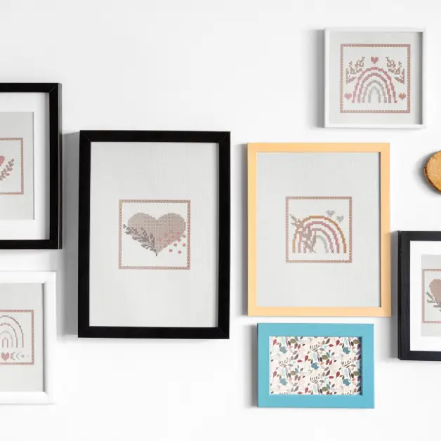 set of six embroidered and framed hearts and rainbows cross stitch