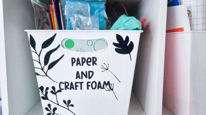 vintage folk floral motifs cut out of black vinyl and decorating a craft storage box that says paper and craft from