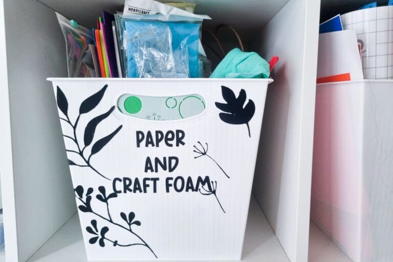 vintage folk floral motifs cut out of black vinyl and decorating a craft storage box that says paper and craft from