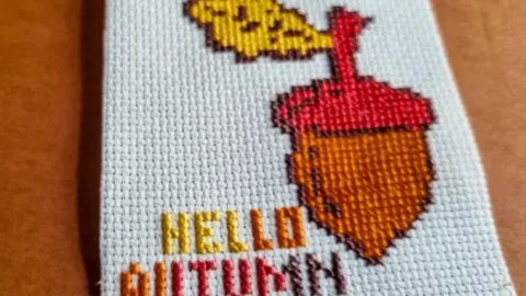 Embroidered acorn cross stitch flat lay