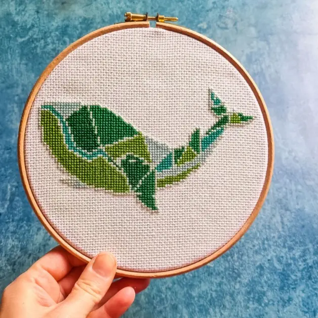 embroidered and framed in a hoop geometric whale cross stitch
