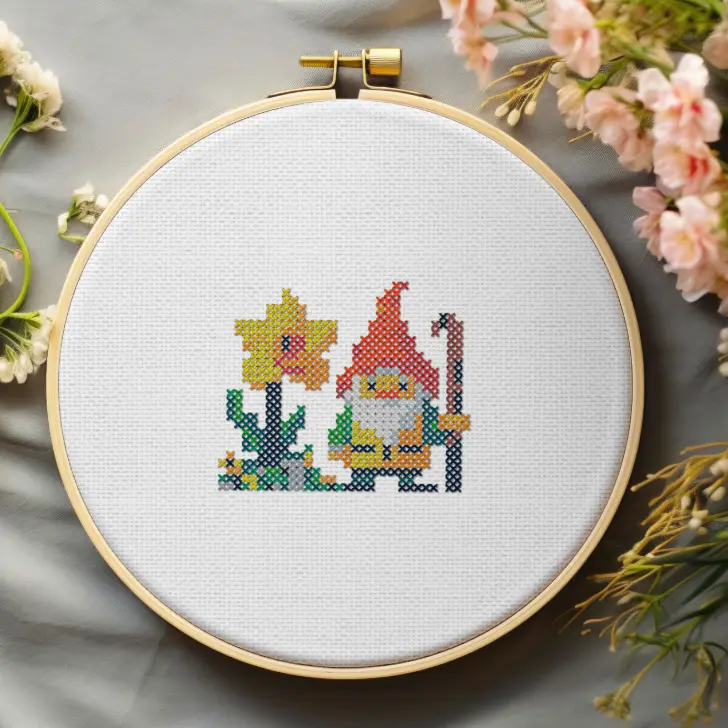 embroidered and framed in a hoop garden gnome cross stitch