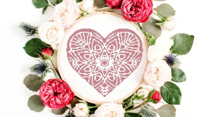 embroidered and framed in a hoop mandala heart cross stitch pattern