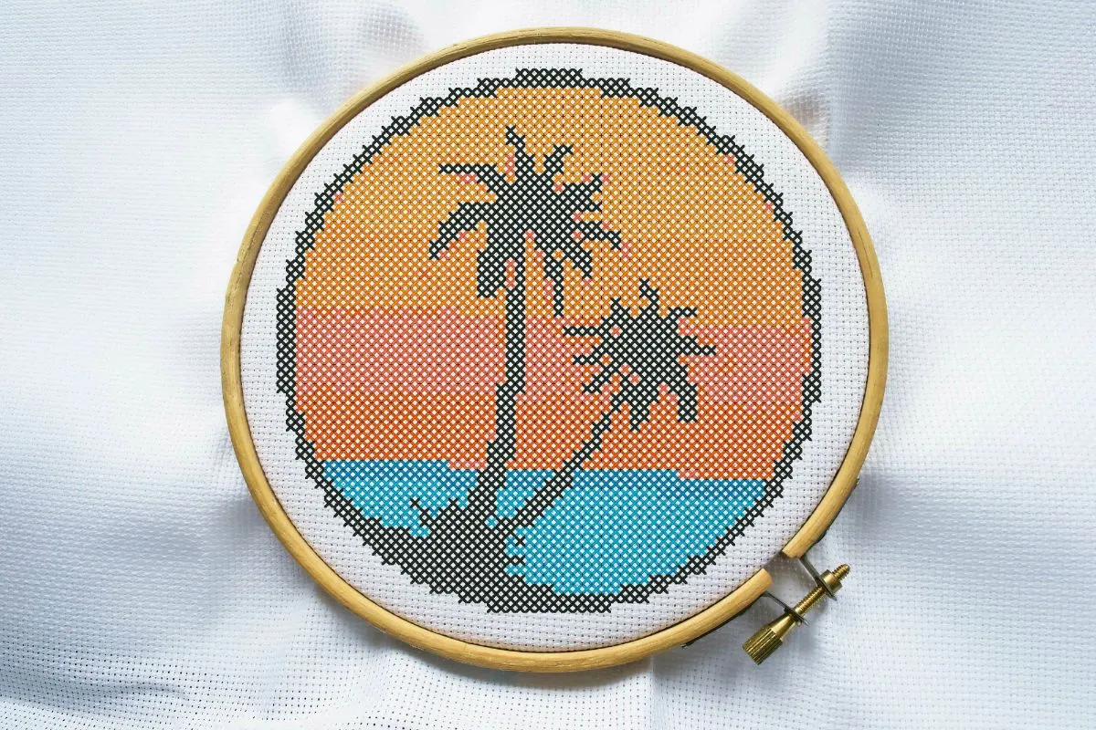 embroidered and framed in a hoop palm tree cross stitch