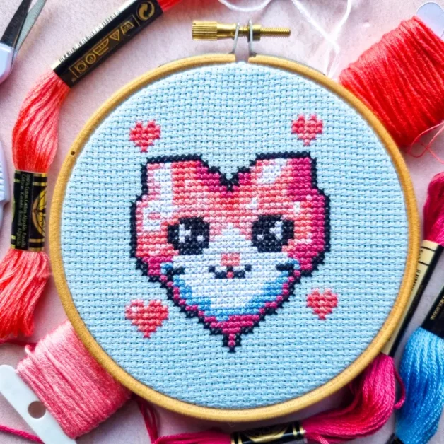 embroidered valentine kitty cross stitch framed in a hoop