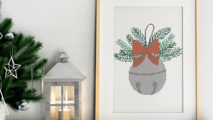 embroidered and framed sleigh bell cross stitch