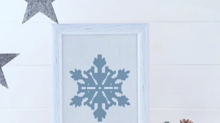 embroidered and framed frozen snowflake cross stitch pattern