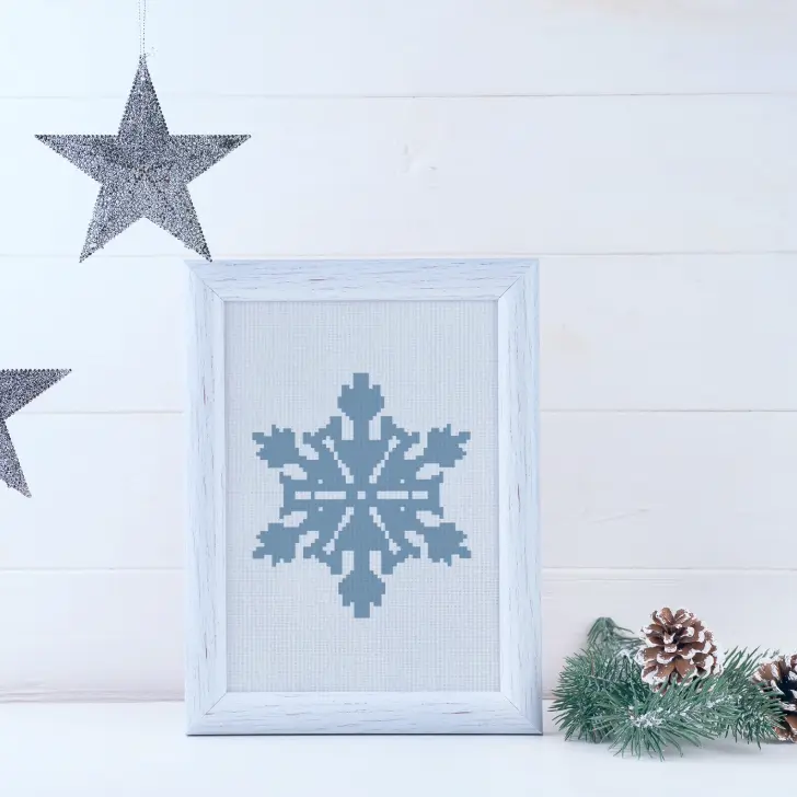 embroidered and framed frozen snowflake cross stitch pattern