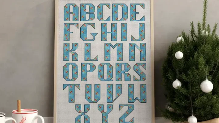 embroidered and framed holly cross stitch alphabet