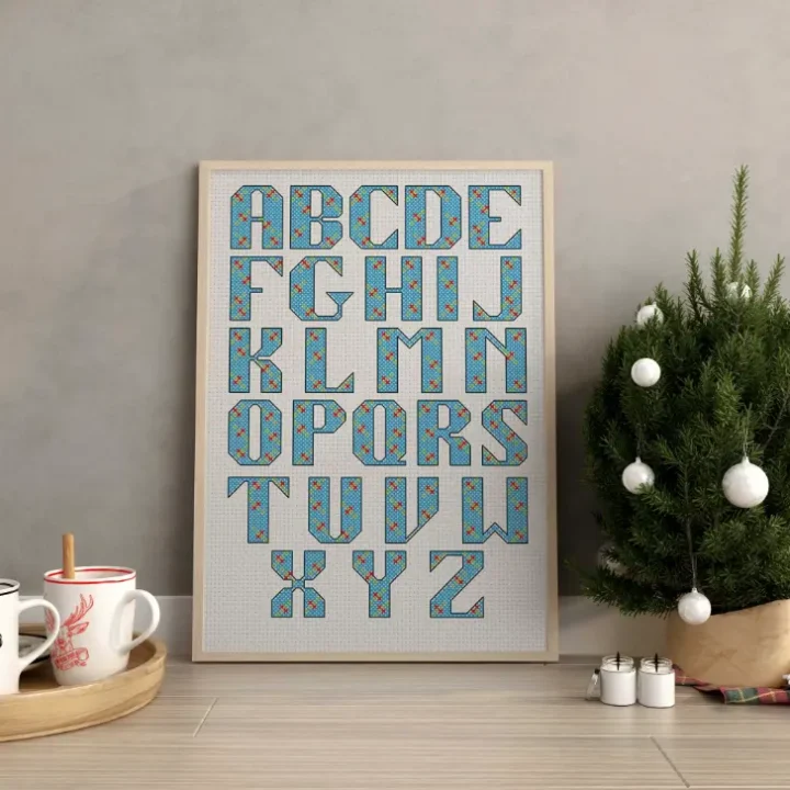 embroidered and framed holly cross stitch alphabet