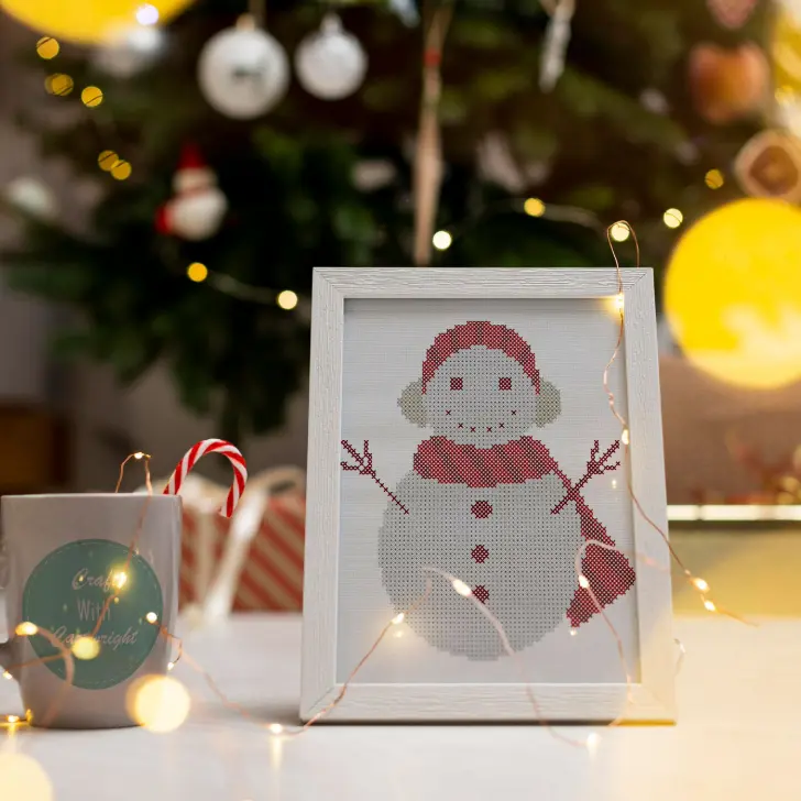 embroidered and framed cosy snowman cross stitch