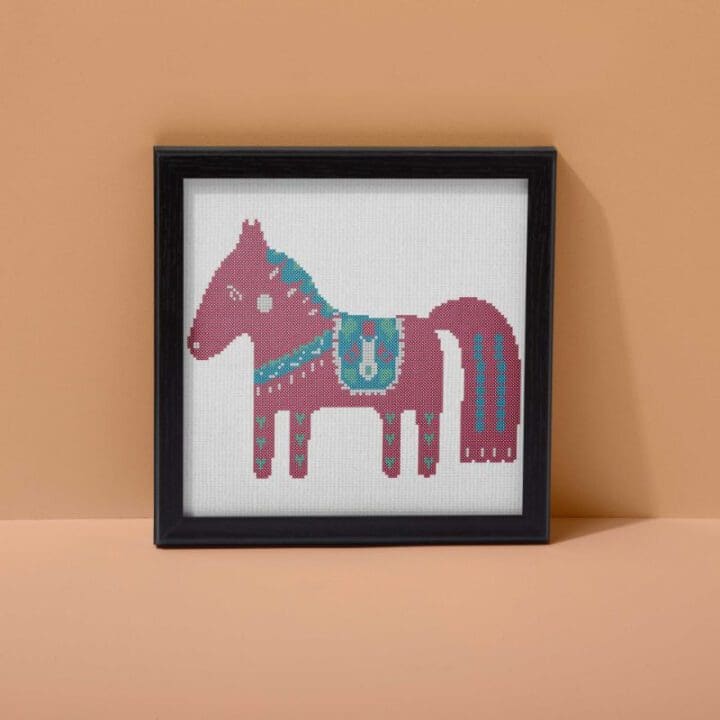 embroidered and framed free red dala horse cross stitch pattern