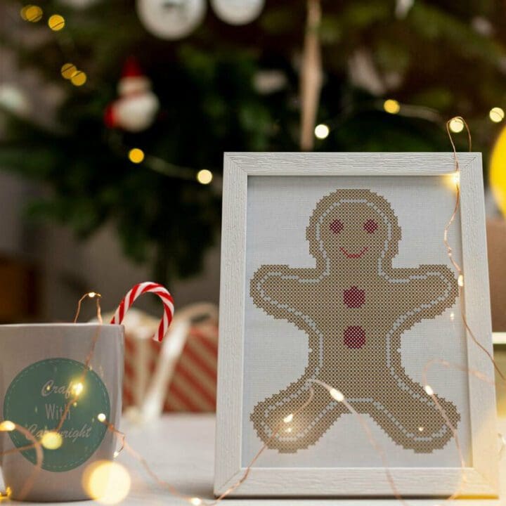 embroidered and framed gingerbread cookie cross stitch