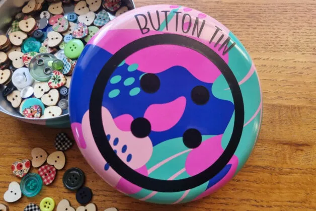 button tin svg used to decorate the top of a metal tin filled with buttons