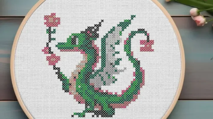 embroidered and framed in a hoop flower dragon cross stitch