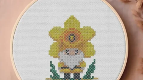 embroidered and framed in a hoop st david's day gnome cross stitch
