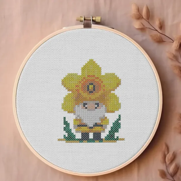 embroidered and framed in a hoop st david's day gnome cross stitch