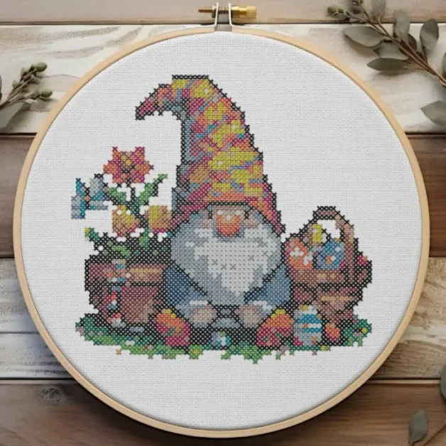 embroidered and framed in a hoop easter gnome cross stitch