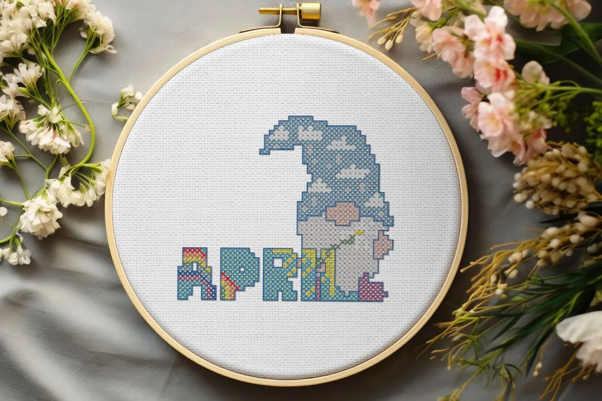 embroidered and framed in a hoop april gnome cross stitch