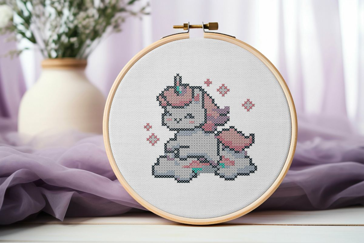 embroidered and framed in a hoop baby unicorn cross stitch