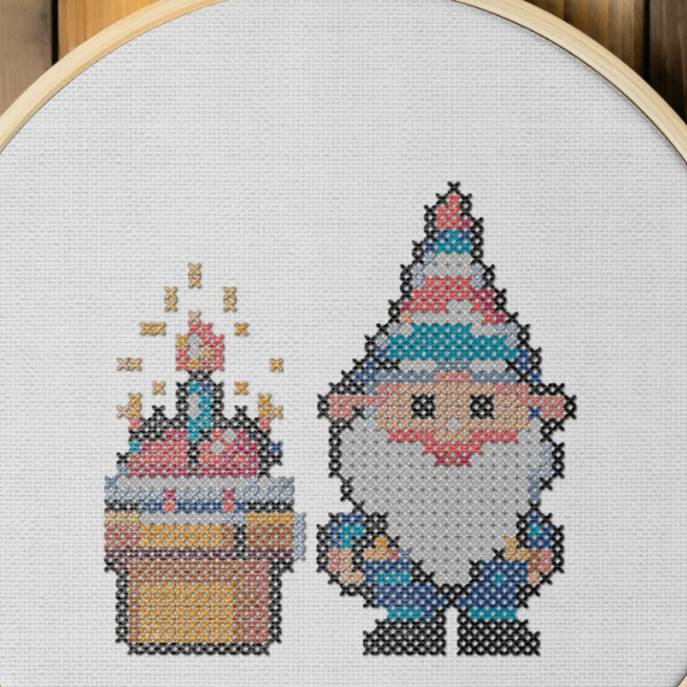 embroidered and framed in a hoop birthday cake gnome cross stitch