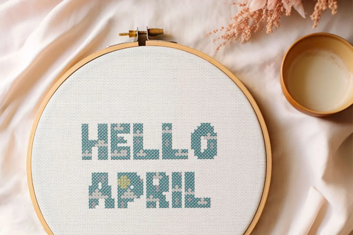 Embroidered and framed in a hoop hello april cross stitch