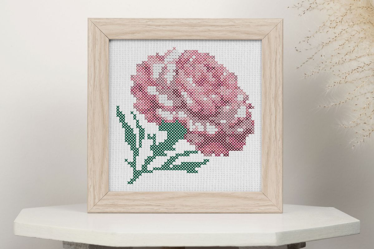 Embroidered and framed, pink carnation cross stitch