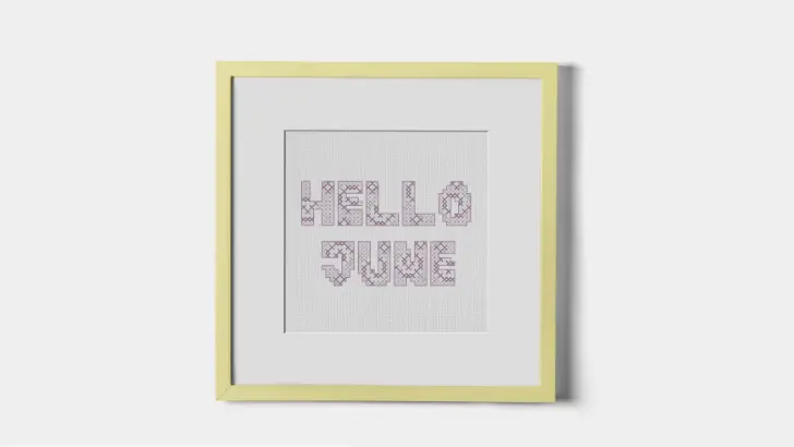 framed and embroidered hello june cross stitch