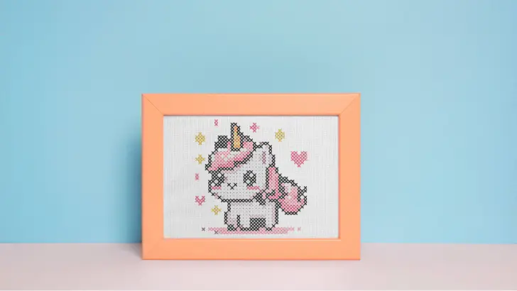 framed and embroidered tiny unicorn cross stitch