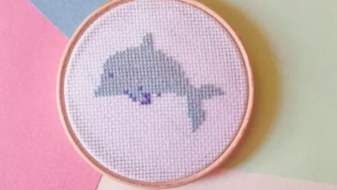 famed in a hoop embroidered tiny dolphin cross stitch pattern