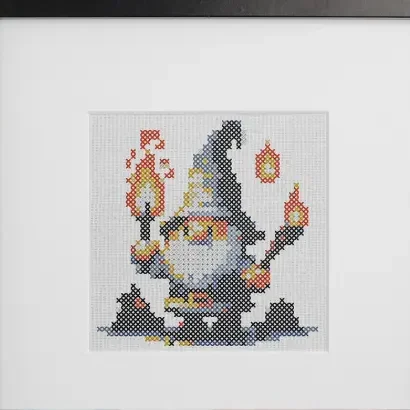 embroidered and framed night time gnome cross stitch