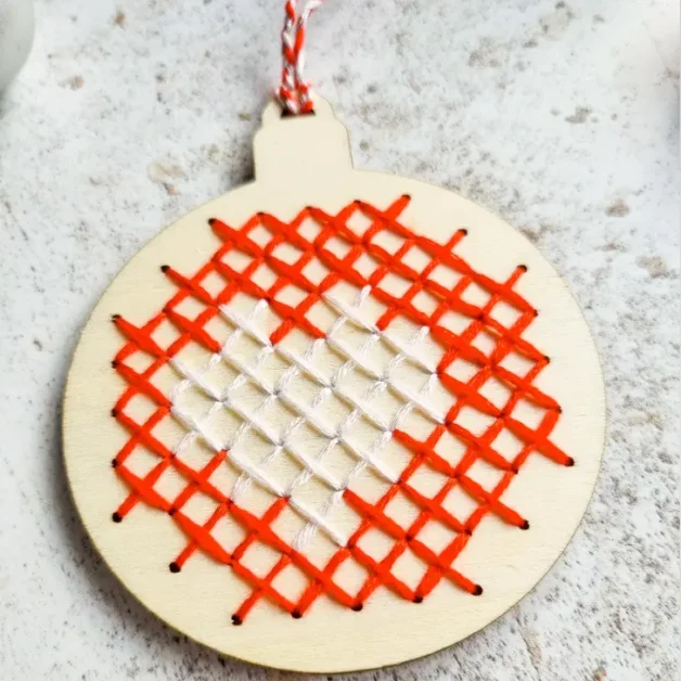 easy christmas bauble cross stitch sewn on a wooden blank