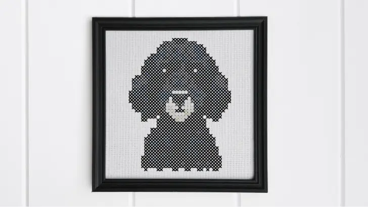 embroidered and framed black labradoodle cross stitch