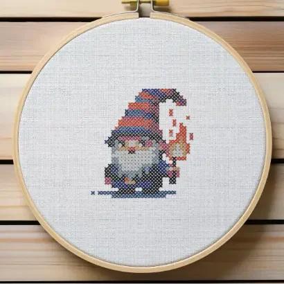 embroidered and framed in a hoop torchlight gnome cross stitch
